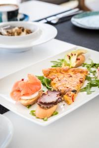 a white plate of food on a table at Amyth of Mykonos Super Paradise in Super Paradise Beach