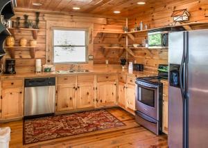 a kitchen with wooden cabinets and a stainless steel refrigerator at Scenic Serenity #75 in Sevierville
