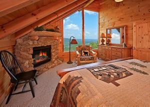 a bedroom with a fireplace in a log cabin at Above It All #38 in Sevierville