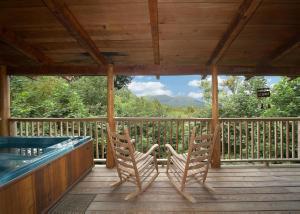 two chairs sitting on a deck with a hot tub at Sequoyah in Cartertown +11 photos