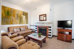 a living room with a couch and a fireplace at Miloca in Playa de Muro
