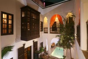 a house with a pool in the middle of it at Riad Alwane in Marrakech