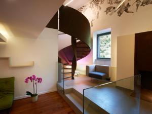 a living room with a glass staircase in a house at The Pinball Luxury Suites in Viterbo