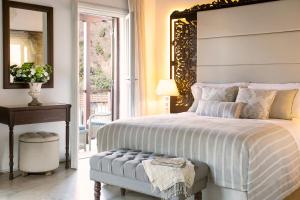 a bedroom with a large bed and a window at Casale Panayiotis in Kalopanayiotis
