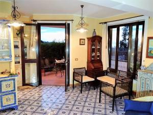 a living room with a door open to a patio at L’altra Sicilia…da Amare in Acquedolci