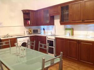 a kitchen with a table with wine glasses on it at Abbey Guest House in Peterhead