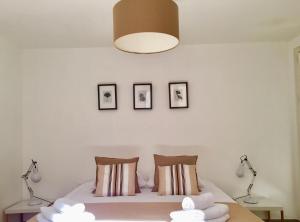 a bedroom with a bed with three pictures on the wall at Le Clos des Salins in Toulouse