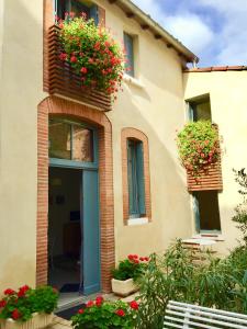 a building with flower boxes on the side of it at Le Clos des Salins in Toulouse