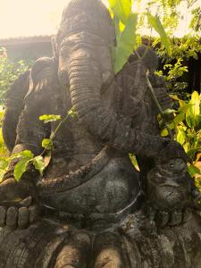 a statue of an elephant with its trunk in the air at Paua Hotel Boutique in Pipa