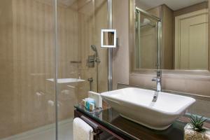 a bathroom with a sink and a shower at Elite World Istanbul Florya in Istanbul