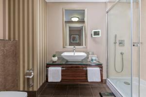 a bathroom with a sink and a shower at Elite World Istanbul Florya in Istanbul
