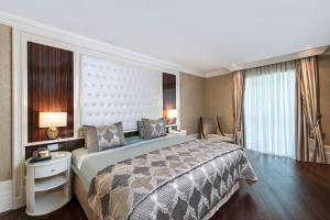a hotel room with a large bed and a window at Elite World Istanbul Florya in Istanbul