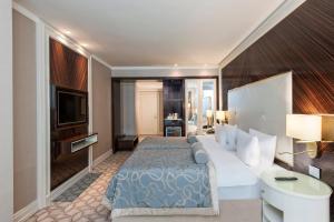 a hotel room with a bed and a television at Elite World Istanbul Florya in Istanbul