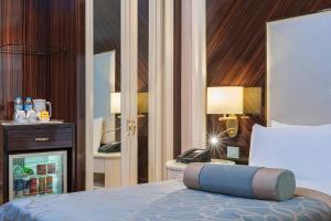 a hotel room with a bed and a phone on a table at Elite World Istanbul Florya in Istanbul