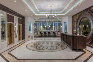 a large lobby with a table and a chandelier at Elite World Istanbul Florya in Istanbul