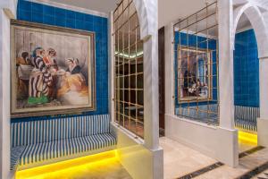 a room with blue walls and a painting on the wall at Elite World Istanbul Florya in Istanbul