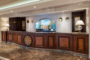 a lobby with a wooden bar in a building at Elite World Istanbul Florya in Istanbul