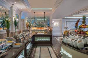 a restaurant with a buffet with food on display at Elite World Istanbul Florya in Istanbul