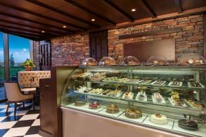 a bakery with a display case filled with pastries at Elite World Istanbul Florya in Istanbul