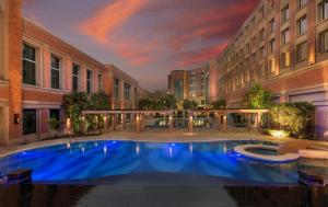 a large swimming pool in the middle of a building at NIRVANA Luxury Hotel l Ludhiana in Ludhiana