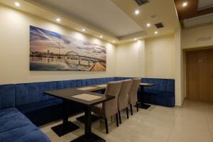 a dining room with a table and chairs at Airport Hotel Garni in Belgrade