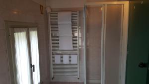 a bathroom with a towel rack with towels at Hotel Sporting in Campagnola Emilia