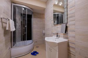 a bathroom with a toilet and a sink and a shower at Airport Hotel Garni in Belgrade