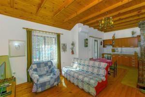 a living room with a couch and a chair at House Silvestra in Borovići