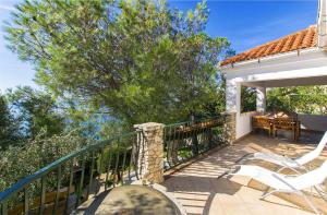 a patio with a table and chairs on a balcony at House Silvestra in Borovići