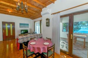 a dining room with a table and a couch at House Silvestra in Borovići