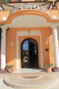 a building with a sign that reads main at Hotel Medusa in Lampedusa