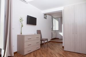 A television and/or entertainment centre at Le Tre Lune Suites