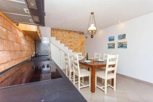 a kitchen with a table and chairs in a room at House Stone house island Prvic in Prvić Šepurine