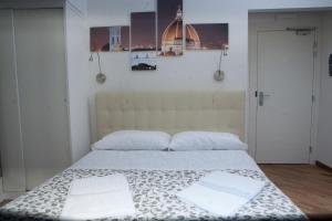 a bedroom with a bed with two towels on it at Le Tre Lune Suites in Florence