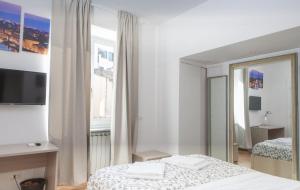 A bed or beds in a room at Le Tre Lune Suites