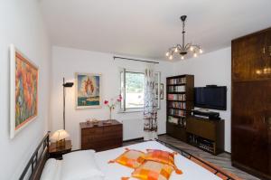 a bedroom with a bed and a tv in it at Apartment Veve in Dubrovnik