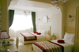 a bedroom with a bed and a dresser at Divas Hotel in Istanbul
