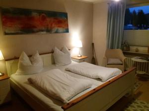 a bedroom with a bed with two white pillows at Strandhaus Nr. 12 in Waldeck