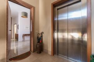 a hallway with a metal door and a mirror at Rialto Bridge Big apt with Lift by LionHost in Venice