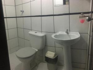 a bathroom with a toilet and a sink at Hotel Fortaleza III Manaus in Manaus