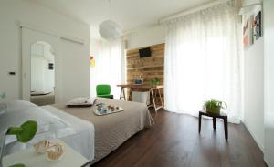 a bedroom with a bed and a desk in it at Nice Hotel Bibione in Bibione