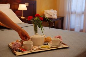 Postel nebo postele na pokoji v ubytování Hotel Borgo degli Olivi