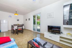 a living room with a television and a dining room at Apartment Vojka in Basina