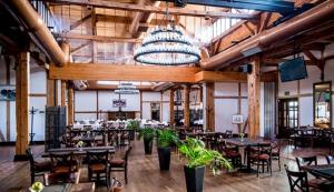 a dining room with tables and chairs in a building at Trzy Korony Boutique Hotel&SPA Piwne in Puławy