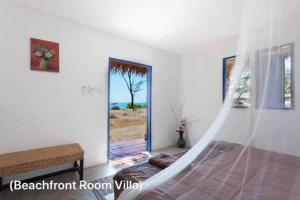 a bedroom with a hammock in a room with a window at Micky Monkey Beach Hotel Phuket Maikhao Thailand in Mai Khao Beach