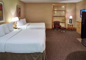 A bed or beds in a room at LivINN Hotel Minneapolis North / Fridley