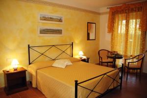 Postel nebo postele na pokoji v ubytování Hotel Borgo degli Olivi
