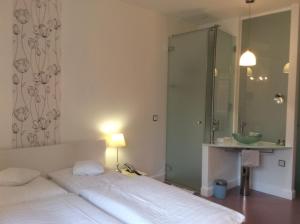 Postel nebo postele na pokoji v ubytování Hotel Heidelberg Astoria