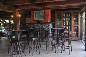 a bar with chairs and tables in a restaurant at Pousada LindnerHof in Rio dos Cedros