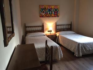 Posteľ alebo postele v izbe v ubytovaní Hostal Argentino
